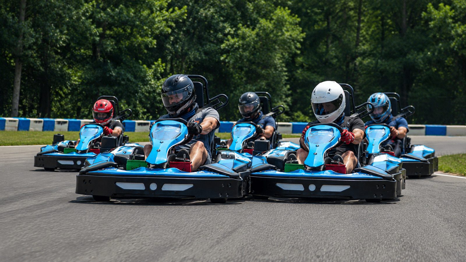 Karts racing wheel-to-wheel on track at the Pro-Am